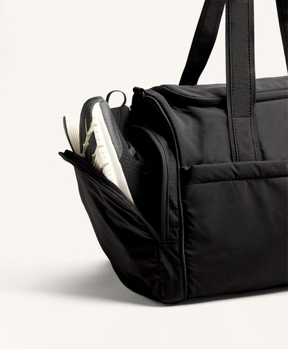 Technical bag with side pockets